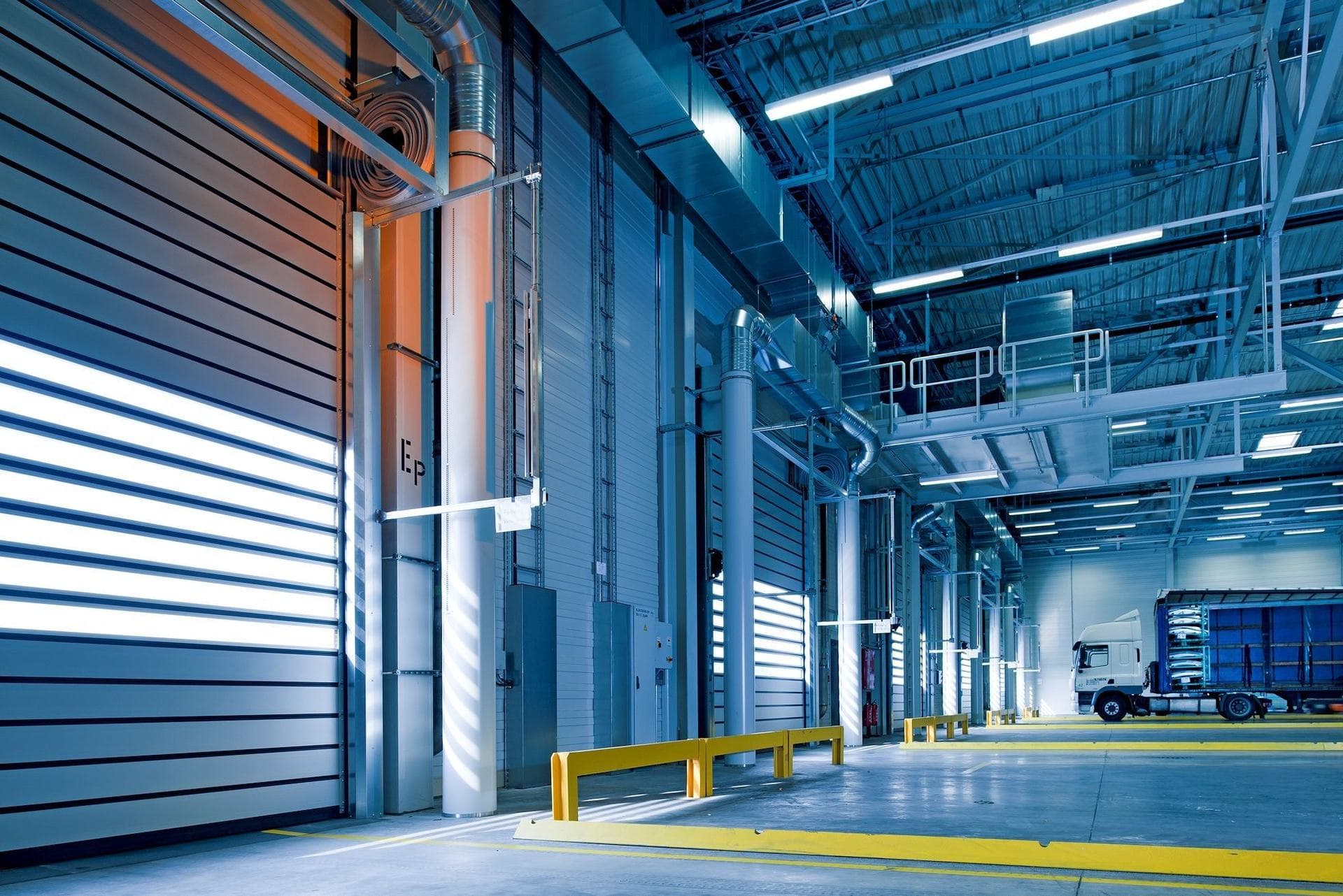 Interior of a KLY steel building system — clear-span frame, insulated envelope and loading doors